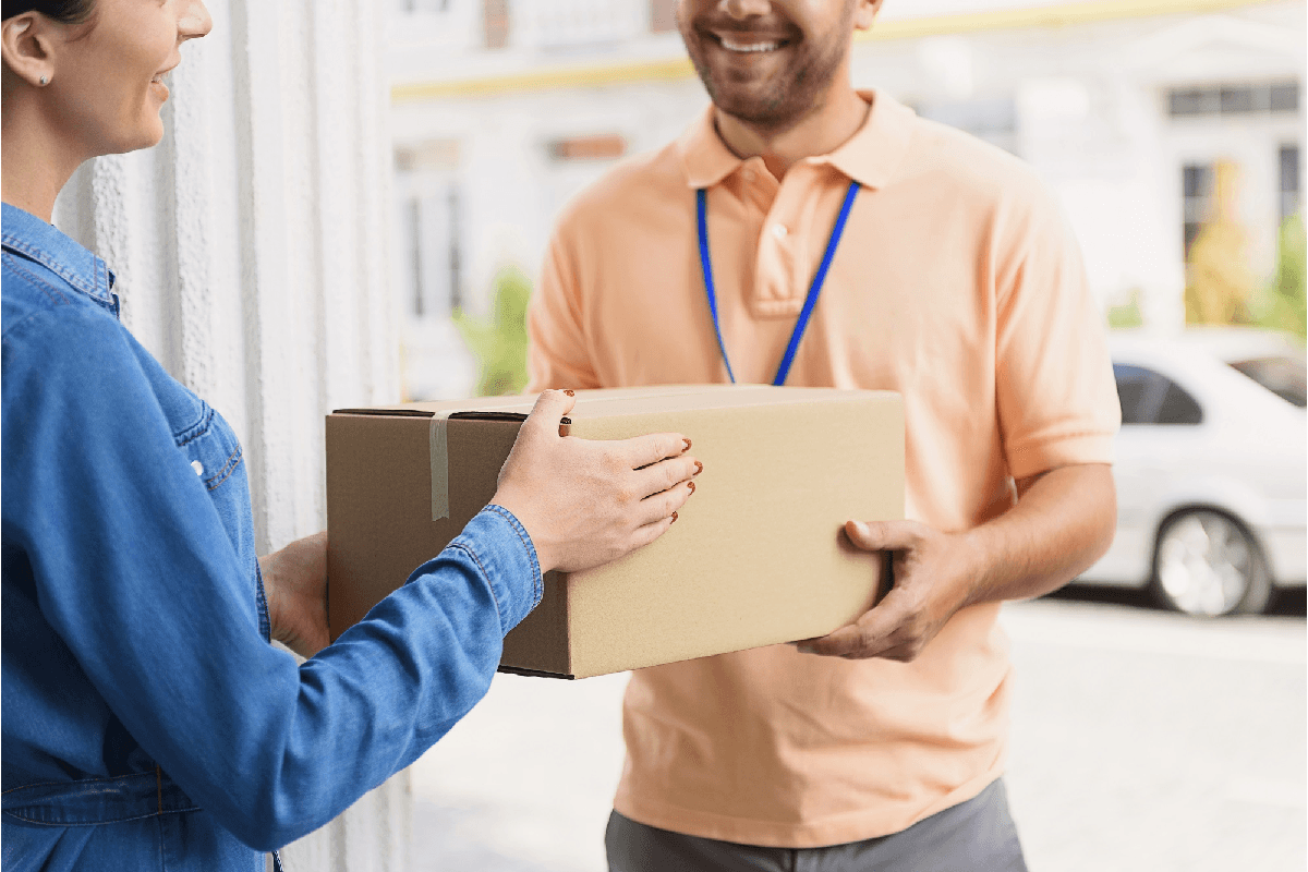 Courier handing off a parcel for Goorooship Canada Inc.